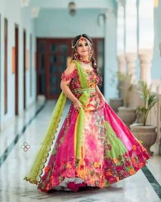 a woman in a colorful dress posing for the camera