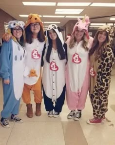 four girls in animal onesuits posing for the camera