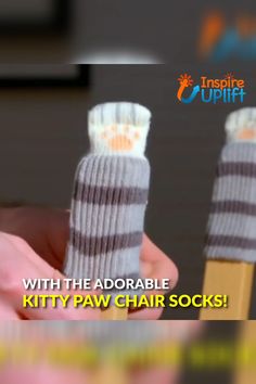 someone holding up two socks with the words kitty paw chair socks