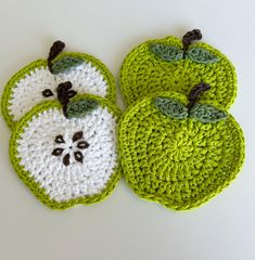 two crocheted apples sitting next to each other