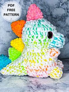 a crocheted stuffed animal sitting on top of a marble surface with the text free pattern