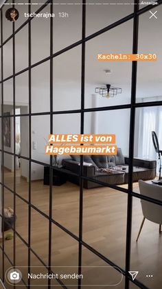 an image of a living room through the bars in front of a door that reads, alles ist von hagebaumark