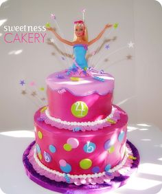 a birthday cake with a barbie doll on top