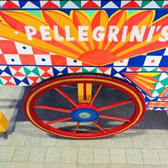 a colorful cart sitting on top of a tiled floor