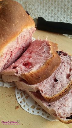 there is a sandwich cut in half on a plate with a knife next to it