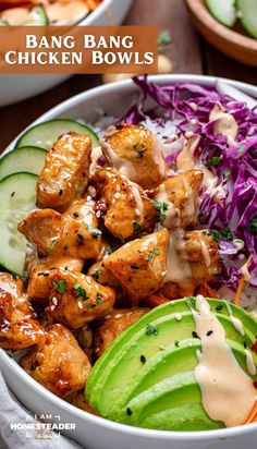 a bowl filled with chicken, coleslaw and cucumber on the side