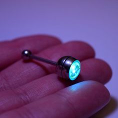 a person is holding a piercing light in their hand