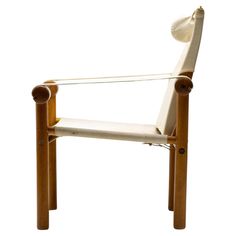 a wooden chair with white fabric on it