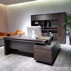 an office desk with a computer on it in front of a couch and bookcase