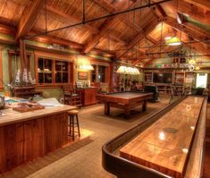 a pool table in the middle of a room with lots of wood paneled walls