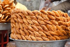 there are many different types of food in the bowl on this street vendor's stand