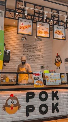 a person behind a counter with food on it