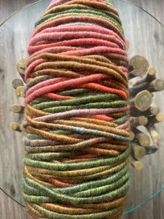 a glass table topped with lots of different colored yarn