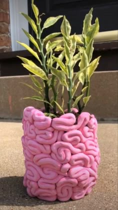 a pink planter made out of fake doughnuts