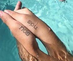 two people holding each other's hands with the words i love you too written on their fingers