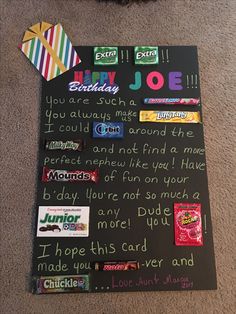 a birthday card with candy, candies and other items attached to it on the floor