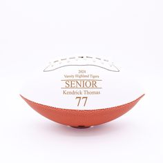 an orange and white football on a white background