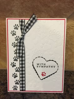 a card with a heart and paw prints on it