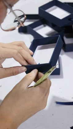 a person cutting something with scissors on a table