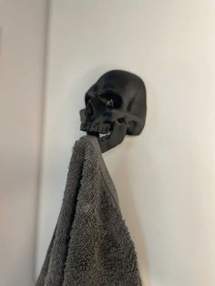 a towel hanging on the wall next to a skull head