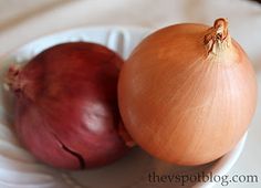 two onions on a white plate next to each other