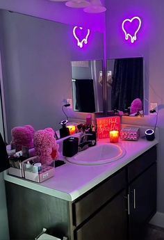 a bathroom vanity with two lights on above it