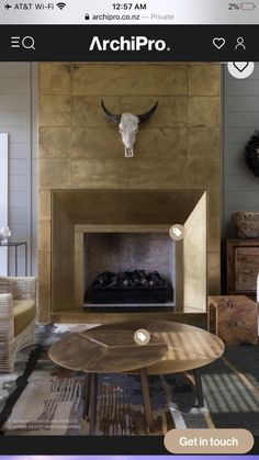 a living room with a fire place and cow skull on the wall