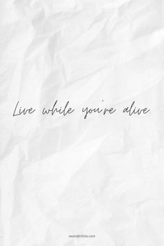 the words live while you're alive written on white paper