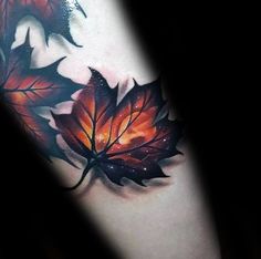 a close up of a tattoo with leaves on it