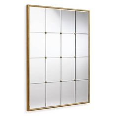 a gold framed mirror on a white wall