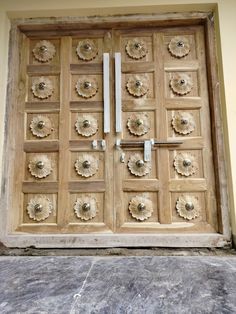 an old wooden door with flowers on it