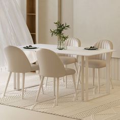 a white table with six chairs and a vase on it in front of a window