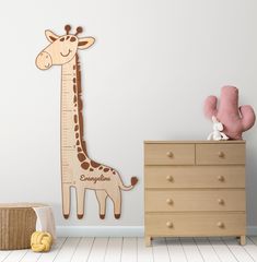 a wooden giraffe standing next to a dresser in a child's room