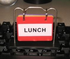 a lunch sign attached to a computer keyboard