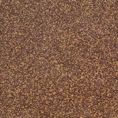 an orange and brown carpet is shown in close up with small speckles on the floor