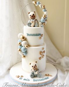 a three tiered cake decorated with teddy bears