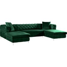 a green velvet sectional sofa with footstool and ottoman in front of a white background