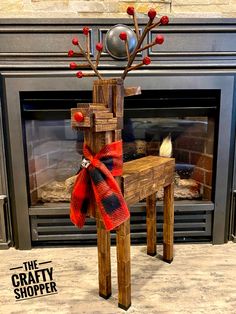 a wooden chair with a bow on it in front of a fire place and fireplace