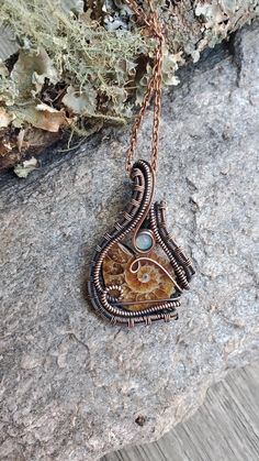 Ammonite Wire Wrapped Pendant, Ammonite Boho Statement Necklace, Heady Festival Handmade Jewelry, Wire Wrap Talisman, Ethiopian Opal Jewelry #4 This ammonite fossil and opal gemstone are wrapped together in copper wire then oxidized for a beautiful antiqued look. Comes with a complimentary waxed cotton cord with a handmade clasp. An antique copper chain is available as an upgrade. Choose cord/chain length in drop down menu before checkout. This pendant measures approximately 2" length by 1 1/4" width.  Your pendant comes packaged in a gift box and ships in 1-3 business days.  ~Ammonite is a stone that will bring about a circulation of energy, making you feel more stable, protected, and grounded in your life. It will convert all your energies that you receive into love and positivity. This Wire Weaving Techniques, Handmade Jewelry Wire, Ethiopian Opal Jewelry, Boho Statement Necklace, Jewelry Care Instructions, Jewelry Wire, Copper Chain, Wrapped Pendant