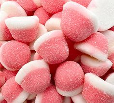 pink and white marshmallows are piled on top of each other