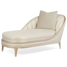 a white chaise lounge chair with pillows on it