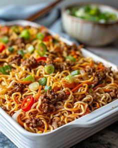 a casserole dish with noodles, meat and vegetables