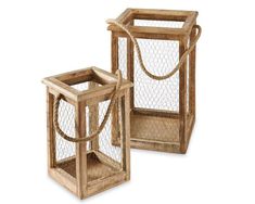 two wooden cages with chicken wire on the top and bottom, one holding a rope