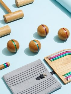 wooden toys are laid out on a blue surface