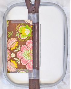 an open zippered case with flowers on it