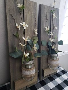 two mason jars with flowers are on display