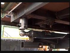 the underside of a vehicle with pipes and wires attached to it's rear end