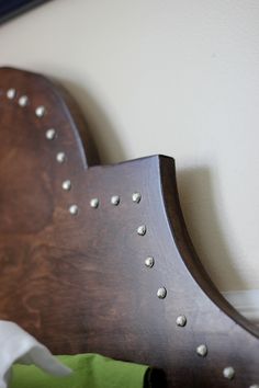 a wooden headboard with metal rivets on it