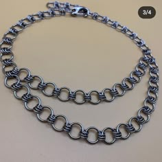 a silver chain is shown on a table