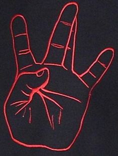 a red light drawing of a hand making the peace sign